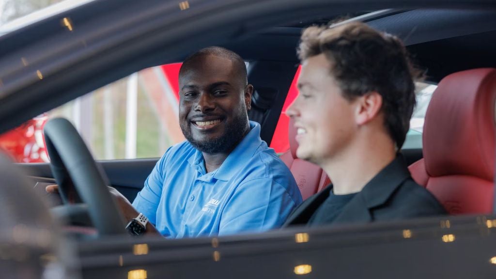 Flow Buick GMC vehicle exchange program - customer in car with sales