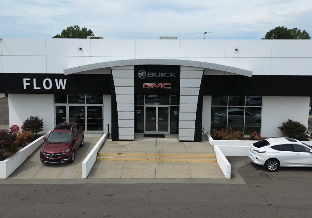 Flow Buick GMC of Winston-Salem dealership storefront with two cars parked in front