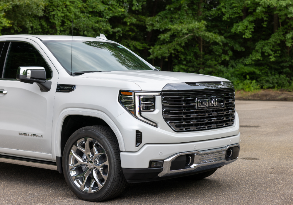 Close up of the front of a white GMC truck for sale